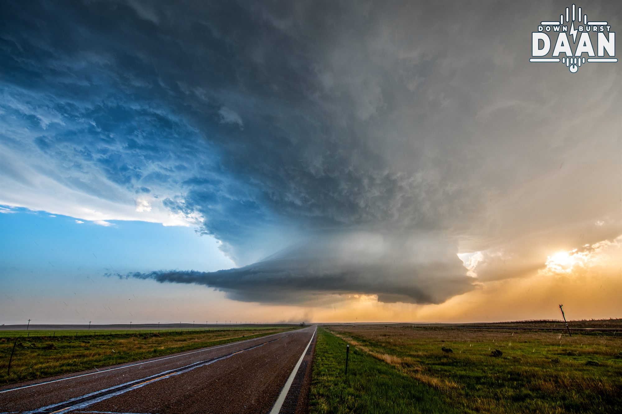 Classic supercell thunderstorm towering over a Great Plains road